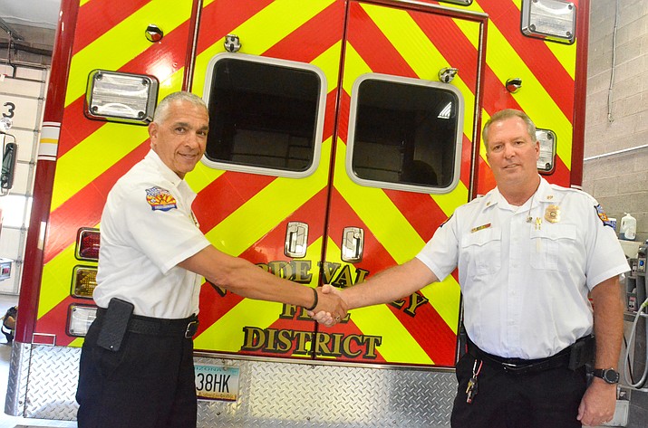 Retiring Chief Nazih Hazime, left, and interim Chief Joe Moore shake hands while having their photo taken on Tuesday. Hazime retires on Wednesday after seven years as chief at the Verde Valley Fire District. Before he was chief in Sedona for two years.  VVN/Vyto Starinskas