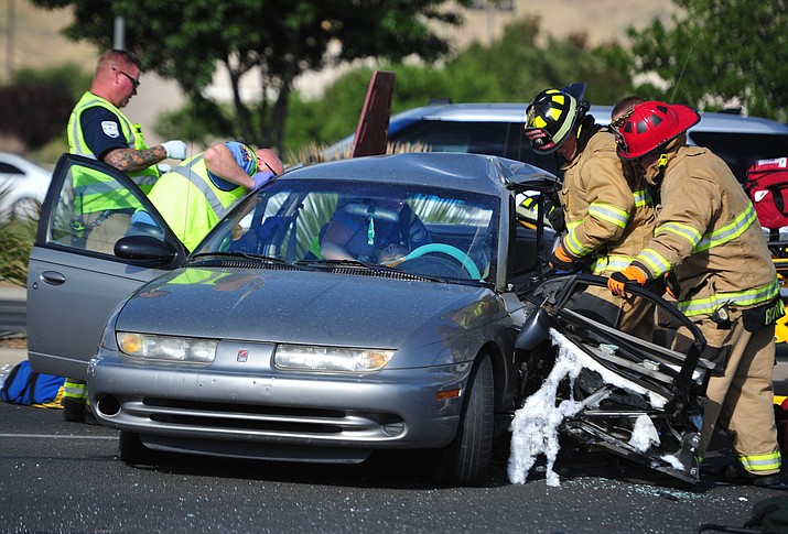 Emergency personnel work to extricate the driver of a sedan after the vehicle was t-boned at the intersection of Glassford Hill Road and Florentine Road Tuesday morning, Sept. 25. 