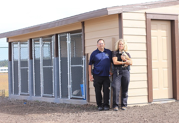 Animal Control Officers Walter Miller and Leah Payne stand outside a new temporary animal holding facility recently completed by city staff. (Wendy Howell/WGCN)