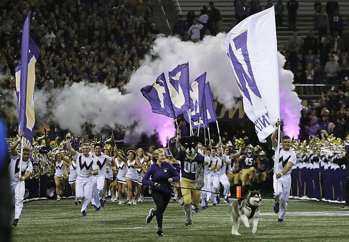 Dubs II, the Washington Huskies live mascot, leads the team out of the tunnel for an NCAA college football game against Arizona State, Saturday, Sept. 22, 2018, in Seattle. (Ted S. Warren/AP)