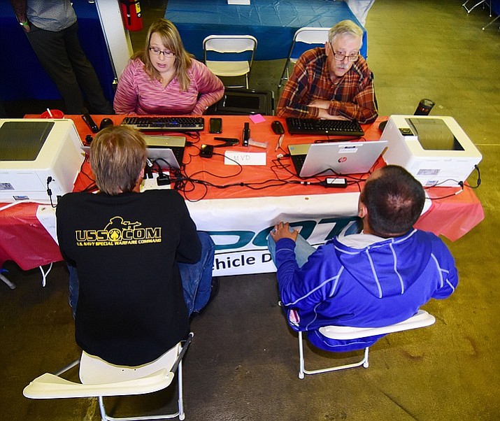 Representatives from the Department of Motor Vehicles help veterans with license or registration problems during the 2017 Veterans Stand Down event at the Frontier Village Shopping Center, Sept. 22, 2017, in Prescott. (Les Stukenberg/Courier file)
