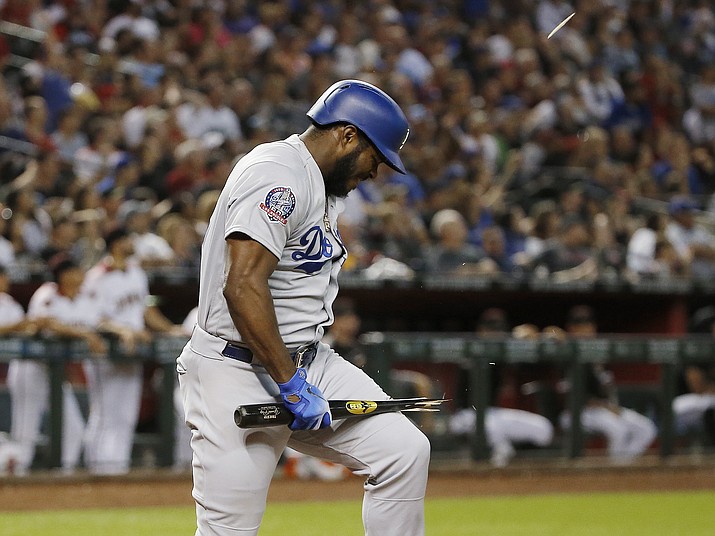 Los Angeles Dodgers' Yasiel Puig breaks his bat over his leg after flyiing out against the Arizona Diamondbacks during the fifth inning of a baseball game Wednesday, Sept. 26, 2018, in Phoenix. (Ross D. Franklin/AP)