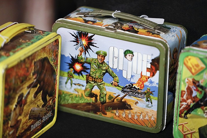 Vintage lunchboxes are displayed at Main Auction Galleries Inc. in downtown Cincinnati. Karp, a longtime auctioneer of Cincinnati-area estates has come upon a Baby Boomer delight: hundreds of vintage lunchboxes featuring the heroes of their childhood’s comic books, TV shows, cartoon strips, movies and more. (John Minchillo/AP)