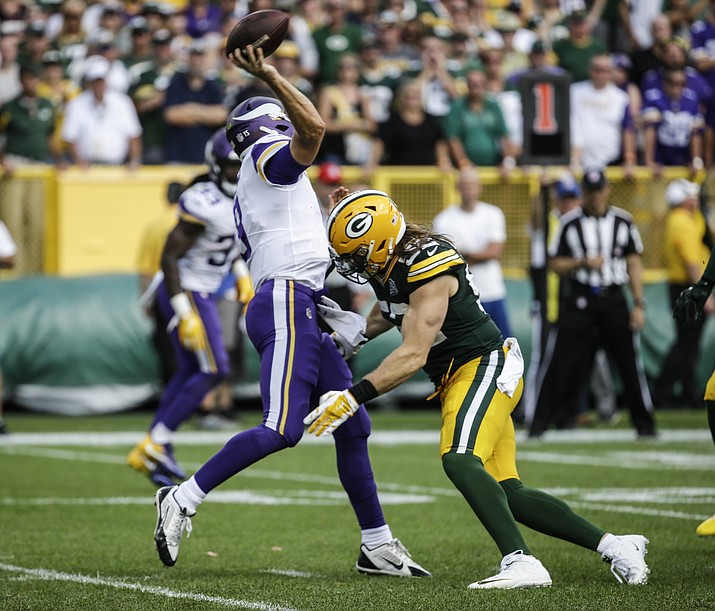 In this Sept. 16, 2018, file photo, Green Bay Packers’ Clay Matthews tackles Minnesota Vikings quarterback Kirk Cousins during the second half of an NFL football game, in Green Bay, Wis. Matthews was penalized for roughing the passer on the play. The NFL is getting roughed up over its amplified enforcement of roughing the passer penalties that has produced head-scratching, game-changing calls and a season-ending injury to a defender trying to comply with the league’s mandate not to land on the quarterback. What constitutes a clean hit anymore is anyone's guess. (Mike Roemer/AP, file)