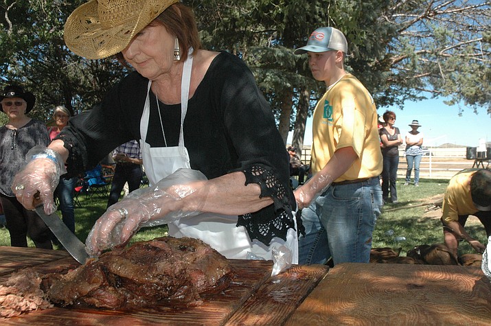 Gloria Samuelson cutting up meat for the event.  (Jason Wheeler/Courier)
