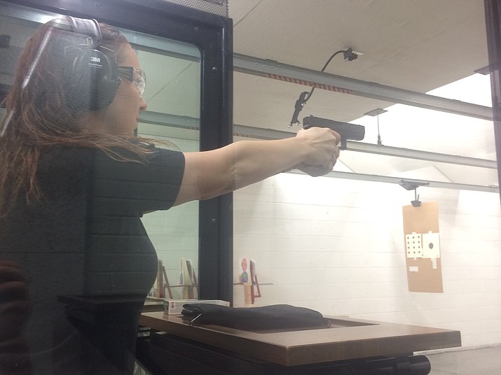 Ivy Jones, general manager at Insight Firearms Shooting Center, makes use of her training to shoot one-hole groups. (Jason Wheeler/Courier)