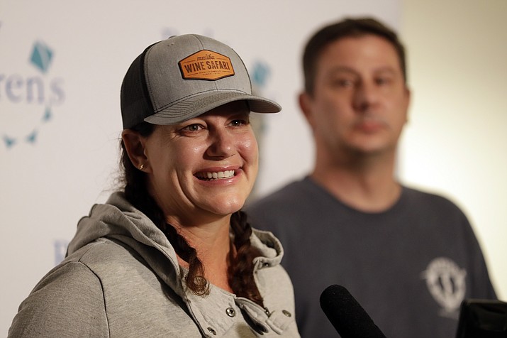 Ellie Hayes, the mother of Keane Webre-Hayes, reacts as she speaks about her son's recovery, alongside her husband, Ben, right, at a hospital Monday, Oct. 1, 2018, in San Diego. Webre-Hayes was expected to recover after a shark attacked him while he dived for lobsters in Southern California, hospital officials said Sunday. (Gregory Bull/AP)