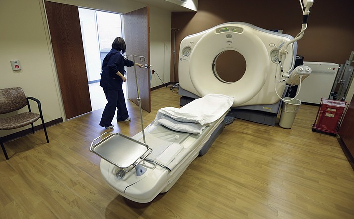 A CT scan technician prepares for a patient on Jan. 9, 2013, at the Silver Cross Emergency Care Center in Homer Glen, Ill. The Trump administration is quietly trying to weaken radiation rules, relying on scientific outliers who argue that a little radiation damage is actually good for you. (M. Spencer Green/AP, file)