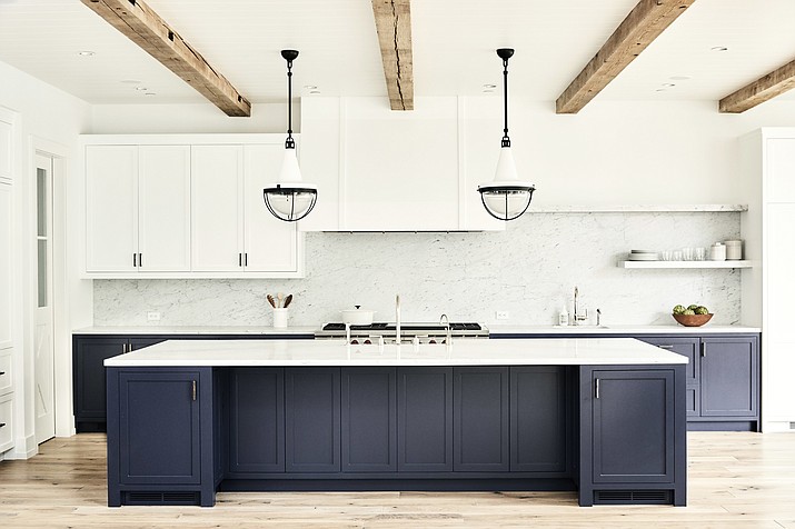 This urban farmhouse style kitchen in a Manhattan Beach, Calif., home was designed by Betsy Burnham. The kitchen island offers ample storage and an extra prep sink for use while cooking. (Jenna Peffley/Betsy Burnham via AP)