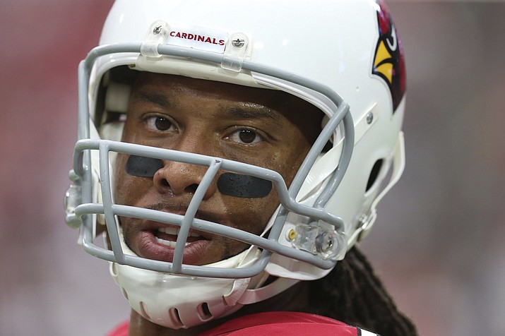 In this Sunday, Sept. 23, 2018, file photo, Arizona Cardinals wide receiver Larry Fitzgerald pauses on the field prior to an NFL football game against the Chicago Bears in Glendale, Ariz. Fitzgerald says it's the wins that keep him playing in the NFL. If that's true, it must have been a pretty miserable first month to his 15th pro season. (Ralph Freso/AP, file)