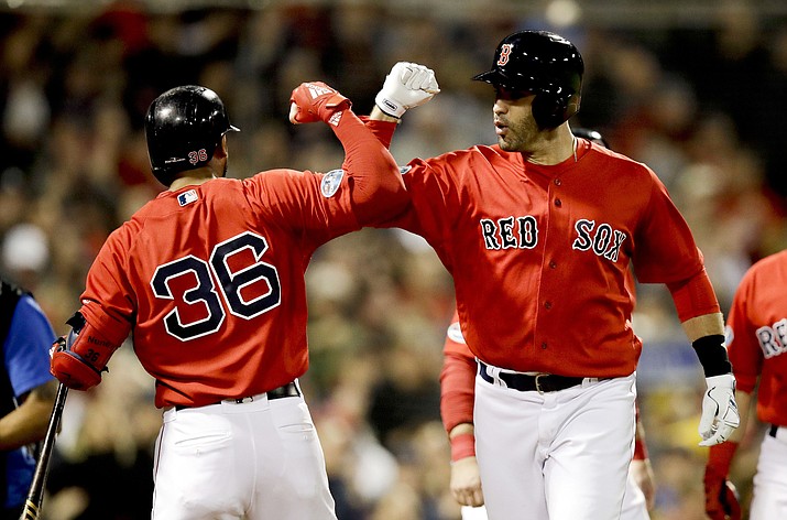Boston Red Sox’s J.D. Martinez celebrates after his three-run home run with Eduardo Nunez during the first inning of Game 1 of a baseball American League Division Series against the New York Yankees on Friday, Oct. 5, 2018, in Boston. (Charles Krupa/AP)