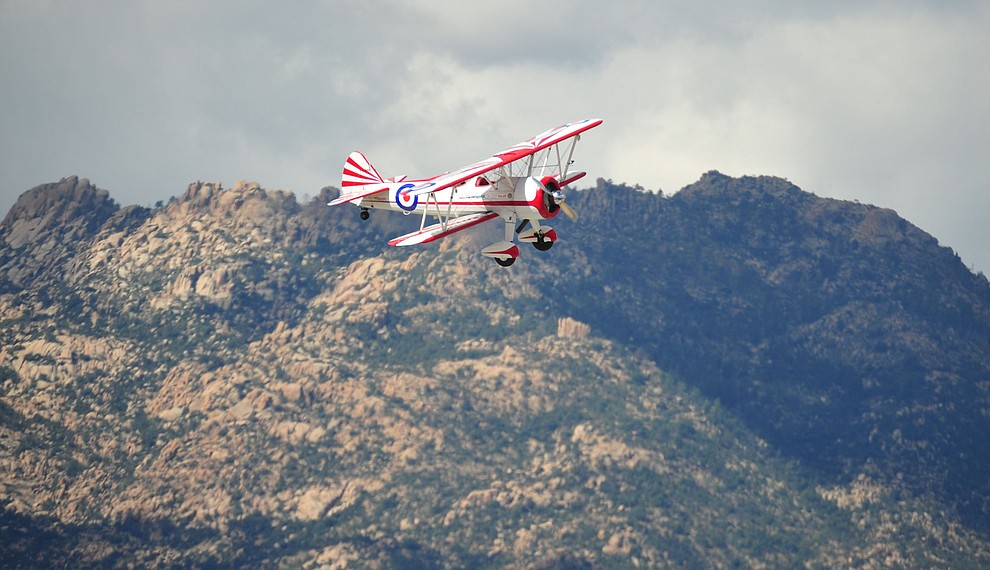 Gary Rower and his SuperStearman biplane with Granite Mountain in the background during the Wings Out West Airshow at Prescott Regional Airport Saturday, Oct. 6, 2018. (Les Stukenberg/Courier)