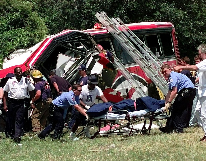 In this May 9, 1999, file photo, emergency workers remove the body of one of the victims of a bus crash in New Orleans, where a chartered bus carrying members of a casino club on a Mother's Day gambling excursion ran off a highway, killing 22 people, in one of the nation's deadliest crashes. A limousine carrying 18 people crashed Saturday, Oct. 6, 2018, in upstate New York, killing all the occupants and two pedestrians, making it among the nation’s deadliest ground-traffic accidents. (AP Photo/Bill Haber, File)

