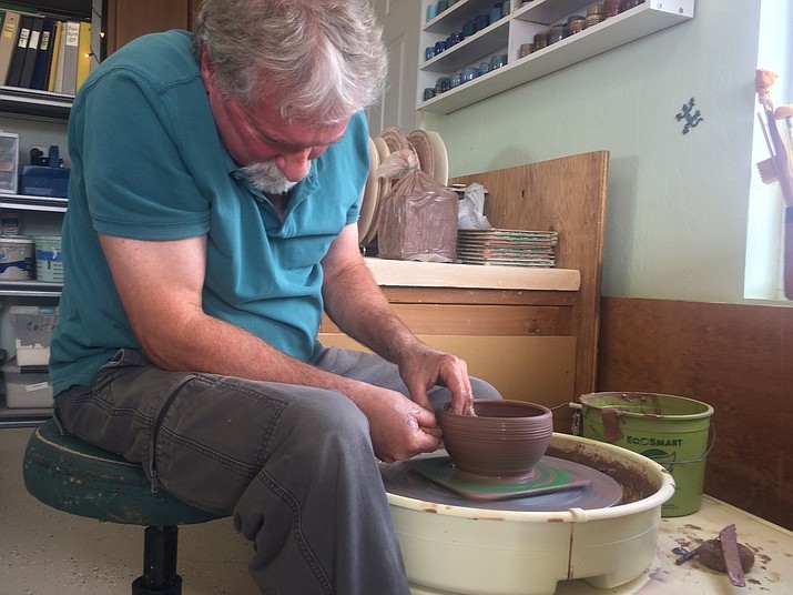 Ceramics artist Michael Brown of LizardHill Pottery demonstrates wheel throwing and throws a bowl during the final day of the Prescott Area Artists Studio Tour at his studio Sunday, Oct. 7. (Jason Wheeler/Courier)