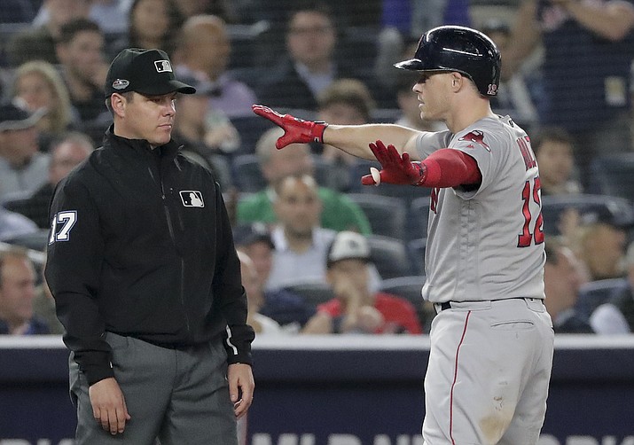 Boston Red Sox’s Brock Holt (12) motions to the Red Sox dugout after driving in two runs in Game 3 Monday, Oct. 8, 2018, in New York. (Frank Franklin II/AP)