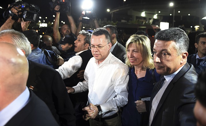 Pastor Andrew Brunson, center left, and his wife Norine Brunson arrive at Adnan Menderes airport for a flight to Germany after his release following his trial in Izmir, Turkey, Friday, Oct. 12, 2018, A Turkish court on Friday convicted an American pastor of terror charges but released him from house arrest and allowed him to leave Turkey, in a move that is likely to ease tensions between Turkey and the United. (AP Photo/Emre Tazegul)