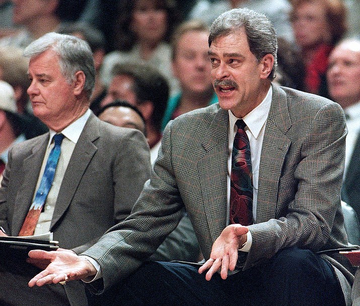 In this 1995, file photo, Chicago Bulls coach Phil Jackson argues a call against his team, as he sits next to assistant coach Tex Winter during the second quarter of an NBA basketball playoff game against the Orlando Magic in Chicago. (Fred Jewell/AP)
