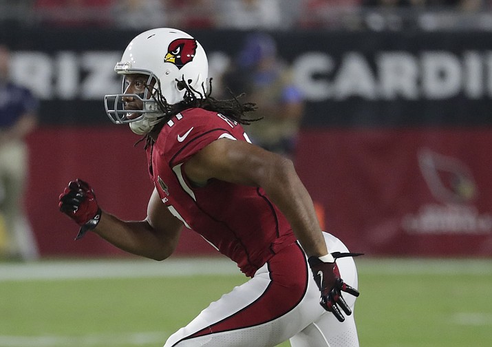 In this Aug. 11, 2018, file photo, Arizona Cardinals wide receiver Larry Fitzgerald (11) runs during the first half of an preseason NFL football game against the Los Angeles Chargers, in Glendale.  Just like Larry Fitzgerald, Adam Thielen grew up in Minnesota trying to emulate star Vikings wide receivers Cris Carter and Randy Moss. Fitzgerald makes what could be his last visit to his hometown as an NFL player with the Arizona Cardinals on Sunday, with Thielen in a starring role with the Vikings. (Rick Scuteri/AP, file)