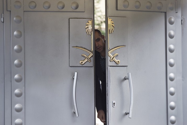 A security personnel looks out from the entrance of the Saudi Arabia's consulate in Istanbul, Sunday, Oct. 14, 2018. Writer Jamal Khashoggi, vanished after he walked into the consulate on Oct. 2. (Petros Giannakouris/AP)