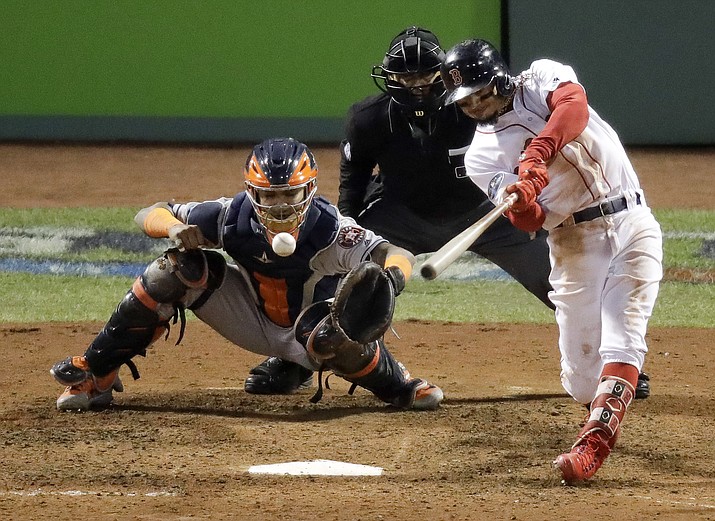 Boston Red Sox's Mookie Betts hits a RBI-double against the Houston Astros during the eighth inning in Game 2 of a baseball American League Championship Series on Sunday, Oct. 14, 2018, in Boston. (Elise Amendola/AP)