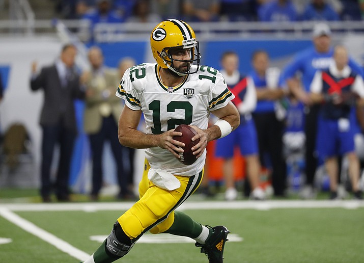 Green Bay Packers quarterback Aaron Rodgers rolls out to pass during an NFL football game against the Detroit Lions in Detroit, Sunday, Oct. 7, 2018. (Paul Sancya/AP)