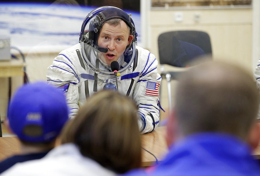 U.S. astronaut Nick Hague, a member of the main crew of the expedition to the International Space Station (ISS), speaks with his relatives through a safety glass prior to the launch of Soyuz MS-10 space ship at the Russian leased Baikonur cosmodrome, Kazakhstan, Thursday, Oct. 11, 2018. (AP Photo/Dmitri Lovetsky)