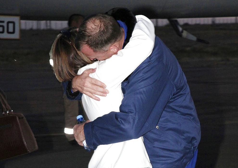 In this photo provided by Roscosmos, U.S. astronaut Nick Hague, right, embraces his wife Catie in Baikonur airport, Kazakhstan, Thursday, Oct. 11, 2018, after an emergency landing following the failure of a Russian booster rocket carrying them to the International Space Station. (Roscosmos via AP)