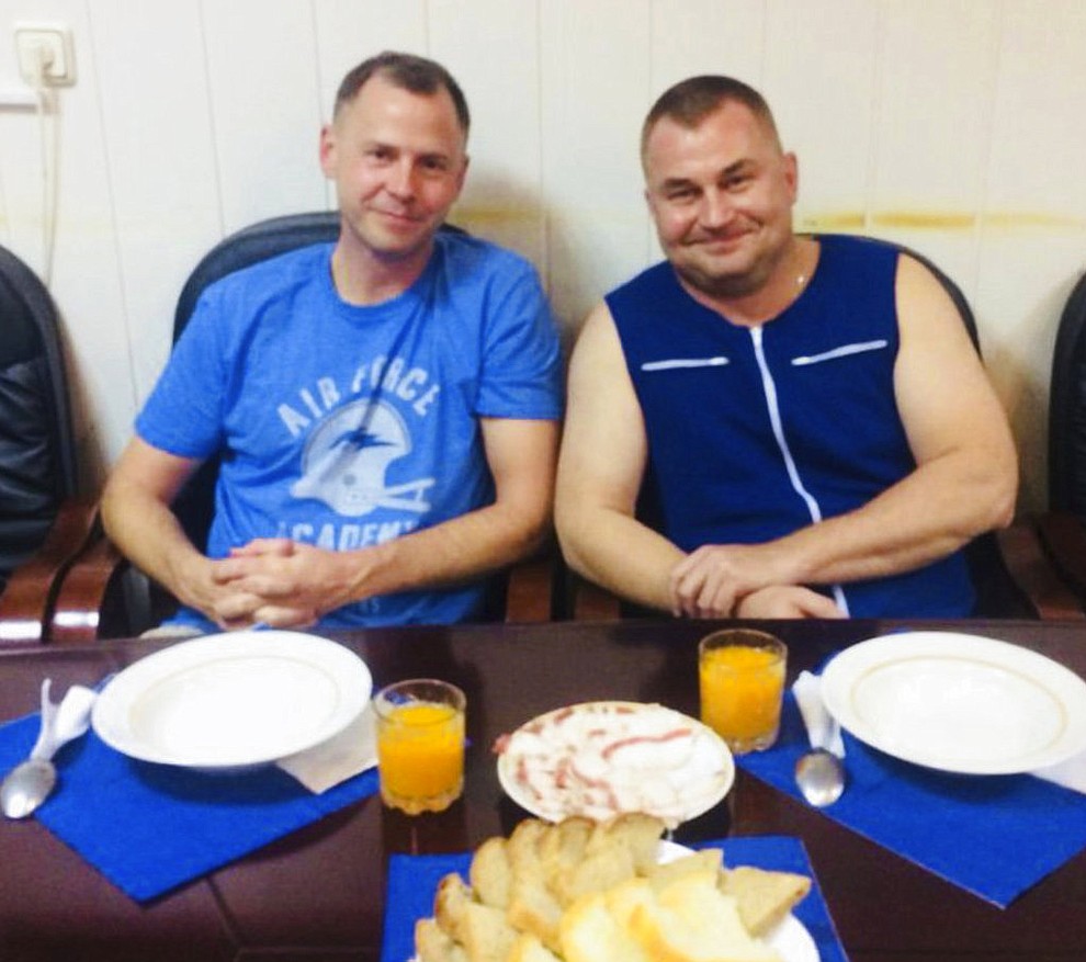 In this photo released by Roscosmos, NASA Astronaut Nick Hague, left, and Roscosmos cosmonaut Alexei Ovchinin pose for a photo in Baikonur, Kazakhstan on Thursday, Oct. 11, 2018, after an emergency landing following the failure of a Russian booster rocket carrying them to the International Space Station. (Roscosmos via AP)