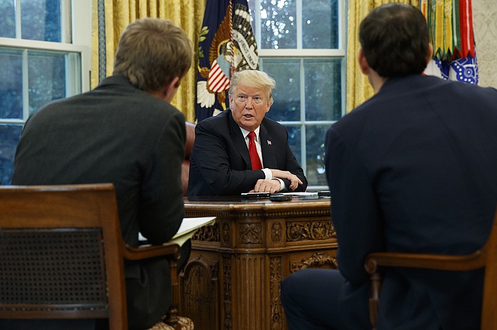 President Donald Trump speaks during an interview with The Associated Press in the Oval Office of the White House, Tuesday, Oct. 16, 2018, in Washington. (AP Photo/Evan Vucci)