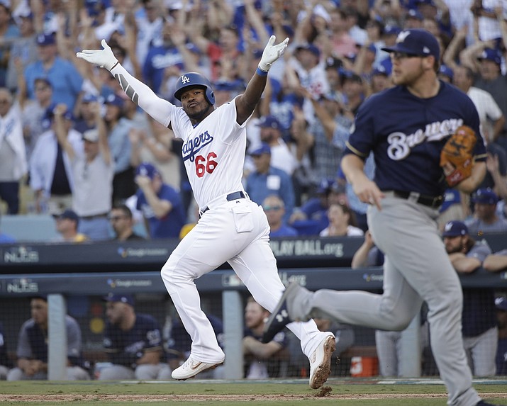 Los Angeles Dodgers' Yasiel Puig reacts after hitting an RBI single during the sixth inning of Game 5 of the National League Championship Series baseball game against the Milwaukee Brewers Wednesday, Oct. 17, 2018, in Los Angeles. (Jae Hong/AP)