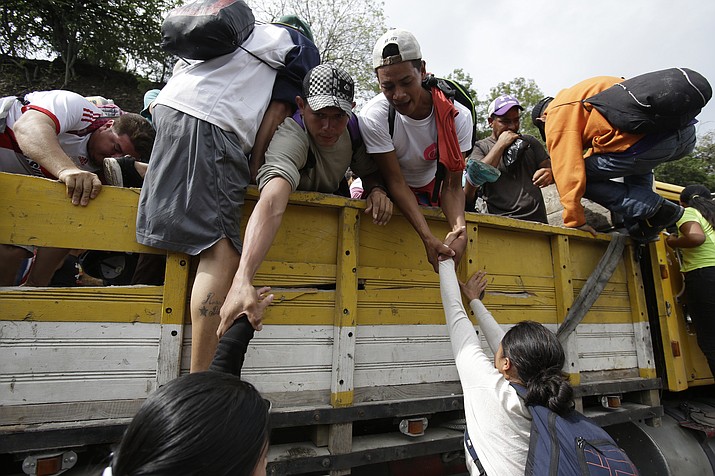 Honduran migrants bound to the U.S border climb into the bed of a truck in Zacapa, Guatemala, Wednesday, Oct. 17, 2018. The group of some 2,000 Honduran migrants hit the road in Guatemala again Wednesday, hoping to reach the United States despite President Donald Trump's threat to cut off aid to Central American countries that don't stop them. (Moises Castillo/AP)