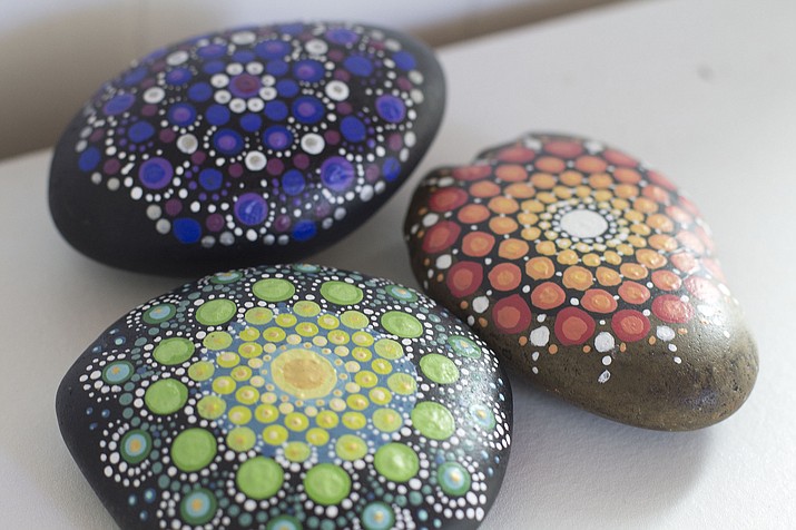 Colorfully-painted mandala stones can serve as pretty paperweights or decorative accents around the home. (Holly Ramer/AP)