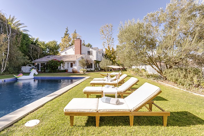 Peter Lorimer says it’s important to include a variety of amenities for guests. At this home in the Bel Air neighborhood of Los Angeles, the owner has provided beach toys and towels for guests to enjoy the pool. (Airbnb Plus via AP)