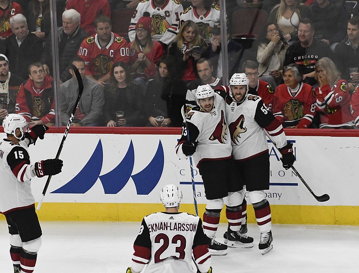 Arizona Coyotes center Vinnie Hinostroza (13) celebrates his goal against the Chicago Blackhawks with defenseman Jason Demers (55) during the second period of an NHL hockey game Thursday, Oct. 18, 2018, in Chicago. (David Banks/AP)
