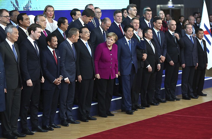 European Union and Asian leaders pose for a group photo during an EU-ASEM summit in Brussels, Friday, Oct. 19, 2018. EU leaders met with their Asian counterparts Friday to discuss trade, among other issues. (AP Photo/Francisco Seco)