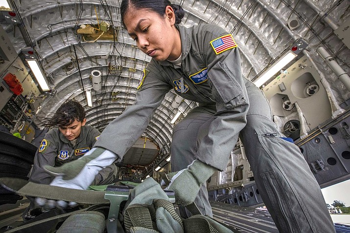 Air Force Staff Sgt. Belinda S. Son, right, and Senior Airman Stephanie Lezcano strap down equipment aboard an aircraft before a training mission at Joint Base McGuire-Dix-Lakehurst, N.J., Oct. 5, 2018.