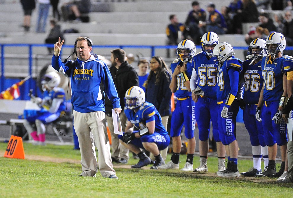 Prescott's Head Coach Cody Collett signals a play in from the sidelines as the Badgers take on Lee Williams Friday, Oct. 19, 2018 in Prescott. (Les Stukenberg/Courier)