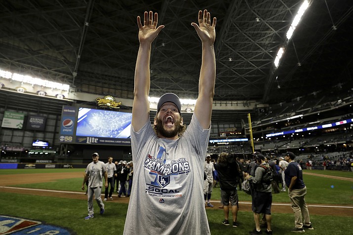 Los Angeles Dodgers’ pitcher Clayton Kershaw celebrates after winning Game 7 of the National League Championship Series baseball game against the Milwaukee Brewers Saturday, Oct. 20, 2018, in Milwaukee. The Dodgers won 5-1. (Matt Slocum/AP)