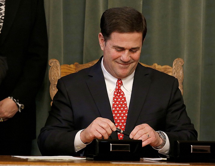 Arizona Republican Gov. Doug Ducey smiles after signing the American Civics Act into law during a bill signing ceremony at the Capitol, Tuesday, Feb. 24, 2015, in Phoenix. (Ross D. Franklin/AP file)