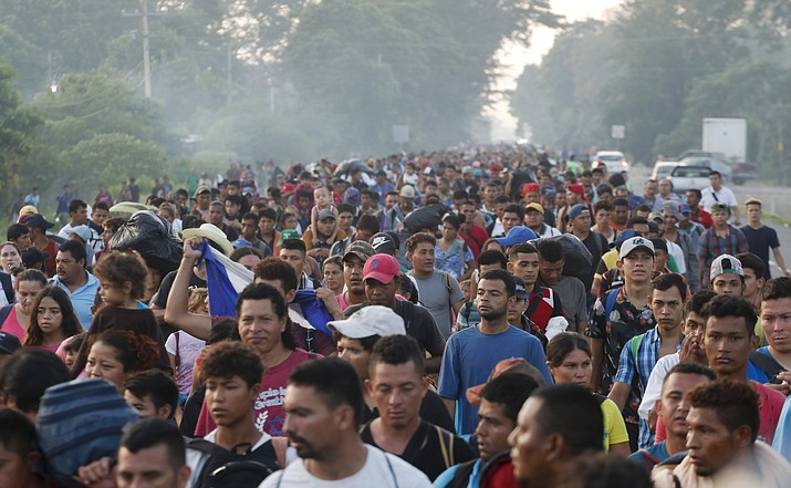Central American migrants walking to the U.S. start their day departing Ciudad Hidalgo, Mexico, Sunday, Oct. 21, 2018. Despite Mexican efforts to stop them at the border, about 5,000 Central American migrants resumed their advance toward the U.S. border early Sunday in southern Mexico. Their numbers swelled overnight and at first light they set out walking toward the Mexican town of Tapachula. (Moises Castillo/AP)