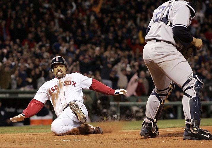 Boston’s  Dave Roberts slides home to score the tying run in the ninth inning of Game 4 of the American League Championship Series against New York on Oct. 17, 2004, in Boston. (Elise Amendola/AP file)