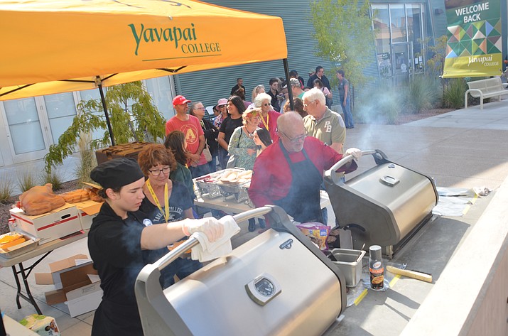 Robert Barr, Culinary & Hospitality Director at Yavapai College, middle, cooks up a barbecue with students and staff at Yavapai College on Saturday during the Yavapai College’s Verde Valley 50th anniversary celebration on Saturday. VVN/Vyto Starinskas