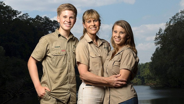 This image released by Animal Planet shows the Irwin family, from left, Robert, Terri and Bindi. The Irwin family is returning to television's Animal Planet, 11 years after the death of "The Crocodile Hunter" star and family patriarch Steve Irwin. The network announced this week that they will work with Animal Planet on television and digital projects that will begin being seen next year. (Animal Planet)