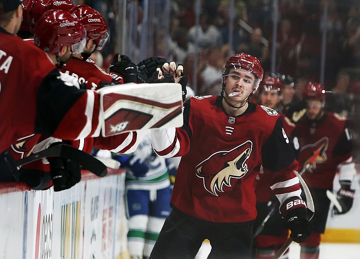 Arizona Coyotes center Clayton Keller (9) celebrates with teammates after scoring a goal in the third period of an NHL hockey game against the Vancouver Canucks, Thursday, Oct. 25, 2018, in Glendale, Ariz. Arizona defeated Vancouver 4-1. (Rick Scuteri/AP)
