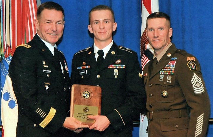 Gen. McConville, (left) presents the award to Spc. Caden Emmons with Sergeant Major of the Army Dan Dailey (right).