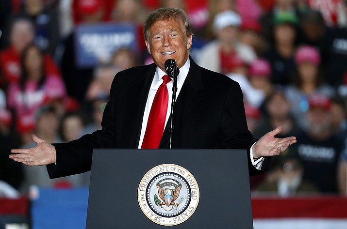 In this Oct. 27, 2018, photo, President Donald Trump speaks during a rally at Southern Illinois Airport in Murphysboro, Ill. Eager to focus voters on immigration in the lead-up to the midterm elections, Trump on Oct. 29 escalated his threats against a migrant caravan trudging slowly toward the U.S. border as the Pentagon prepared to deploy thousands of U.S. troops to support the border patrol. (AP Photo/Jeff Roberson)