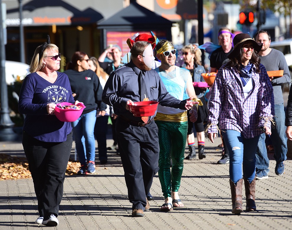 Prescott Unified School District employees walk to greet students from Lincoln Elementary School as they hold their annual Halloween parade around the Courthouse Plaza in Prescott Wednesday, Oct. 31, 2018.  (Les Stukenberg/Courier).