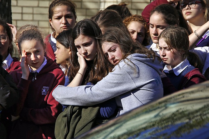 Students from the Yeshiva School in the Squirrel Hill neighborhood of Pittsburgh stand outside Beth Shalom Synagogue after attending the funeral service for Joyce Fienberg, Wednesday, Oct. 31, 2018. Fienberg, 75, Melvin Wax, 87, and Irving Younger, 69, were to be laid to rest as part of a weeklong series of services for the 11 people killed in a shooting rampage at the Tree of Life synagogue Saturday. (Gene J. Puskar/AP)