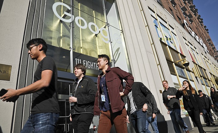 Google employees walk off the job in a protest against what they said is the tech company's mishandling of sexual misconduct allegations against executives on Thursday, Nov. 1, 2018, in New York. (AP Photo/Bebeto Matthews)