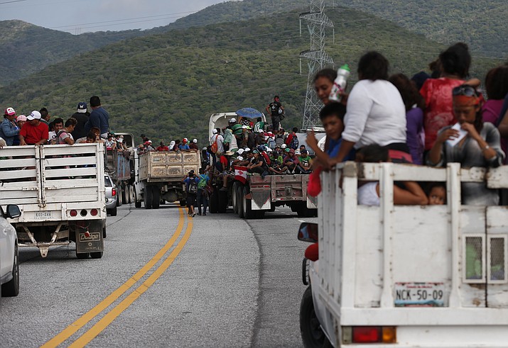 Migrants hitch rides in the back of trucks as the thousands-strong caravan of Central Americans hoping to reach the U.S. border moves onward from Juchitan, Oaxaca state, Mexico, Thursday, Nov. 1, 2018. Thousands of migrants resumed their slow trek through southern Mexico on Thursday, after attempts to obtain bus transport to Mexico City failed. (Rebecca Blackwell/AP)